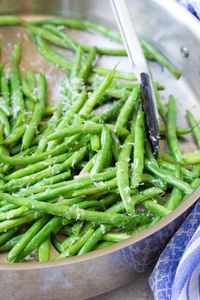 These sautéed green beans are crisp and fresh and so simple to make! These Skillet Parmesan Green Beans are an easy side dish for any meal. You can add garlic to this healthy recipe.