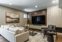 This beautiful basement renovation features an earthy colour palette, modern finishes and warm wood tones throughout. With a custom bar area, pool table and large walnut panelled feature wall this is the perfect sophistaced yet cozy family space.