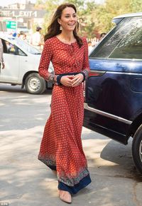 Relaxed: Kate wore flat cream pumps underneath a long burgundy ethnic style dress with a b...