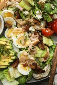 While the origins of a Cobb salad are still up for debate, what goes into one is fairly absolute: tender chicken breast, tangy tomatoes, perfectly hard-boiled egg and, perhaps most important, crispy bacon This classic version relies on crumbled blue cheese and ripe avocado for creaminess, rather than a cheese or buttermilk-based dressing, making way for a mustardy shallot vinaigrette The way each of the ingredients is prepared will depend on personal preference: Are you a chunky, chopped sala...