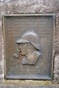 A plaque at the Reichenbach Falls in Bernese Oberland, Switzerland, commemorates the place where Sherlock Holmes and Moriarty apparently fell down fighting. Sherlock Holmes, of course, survived. This happened in "The Final Problem."