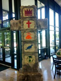 Entry area Pillar: Use foam board & cut out windows for symbols: Crown, Cross, Big Footprint w/ little one inside??, Binoculars, Globe. (Foam board base)