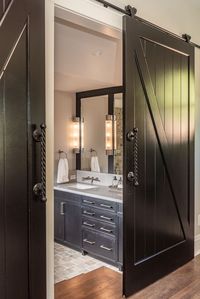 This master bath retreat uses Natural stone to surround in luxury with a freestanding tub perfect for those at home spa days #bath #masterbath #bathroominspo #bathroominspiration #naturalstone #wetroom #wetroominspiration #barndoors #farmhouse #modernbarndoor #modernfarmhouse