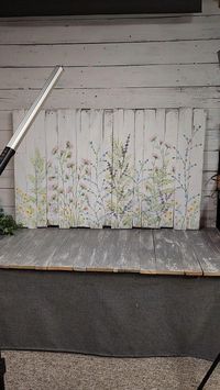 This farmhouse decor style headboard would be adorable in a little girl's bedroom or in a sunny guest room. Hand painted loose wildflowers on pallet wood aged white paint.