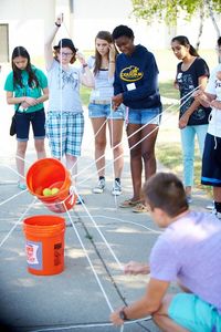 Team building exercise, atomic waste. Everyone has to work together to get the balls from one bucket into the other without spilling.