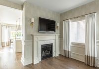 This charming bungalow had a great layout and good bones, but needed some updating and style. We completely gutted the kitchen and bathrooms and added personality with beautiful embossed wallpaper in the dining room and applied moulding in the living room. Custom panel draperies and beautiful marble looking wall tile in the master bathroom add warmth and texture. My absolute favourite feature is the wall panelling and marble floor and wall tile in the guest bathroom!