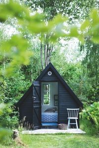 This minimalistic triangular cottage-inspired she shed is SO luxe.