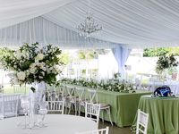 Leaf + Petal NOLA created a garden style wedding reception at Old Ursuline Convent in New Orleans using neutral garden roses, spray roses, ranunculus, and lush greenery.