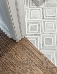 This charming bungalow had a great layout and good bones, but needed some updating and style. We completely gutted the kitchen and bathrooms and added personality with beautiful embossed wallpaper in the dining room and applied moulding in the living room. Custom panel draperies and beautiful marble looking wall tile in the master bathroom add warmth and texture. My absolute favourite feature is the wall panelling and marble floor and wall tile in the guest bathroom!
