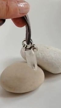This handmade unique piece of jewelry is made to wear almost in any occasion and to be combined with any jewelry of your choice. The crystal quartz has healing properties and is commonly used for spiritual protection. This raw clear crystal quartz is set in sterling silver and has a small cabochon with a tiny freshwater pearl. An unique and original pendant that you may wear with a chain, leather or any chord you like. We provide a grey suede chord that you can adjust to the length you like.