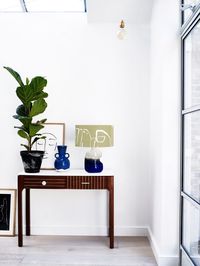 If you have a small entryway, think about using light colours to open the space visually. One thing you need to keep in mind is to not clutter up the area and limit the accents to one or two pieces. Switch the sideboard with a sleek console to further streamline the look. Image courtesy, Oliver Bonas