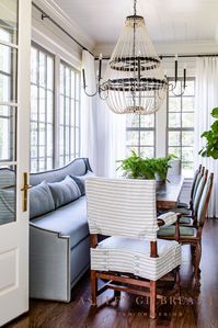 ASHLEY GILBREATH INTERIOR DESIGN: To have this much seating and natural light in your breakfast nook! Wow!! A custom, upholstered banquette paired with antique European dining chairs is the dream for every lake house and all their guests!
