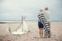 Couple Looking at Tent on the Beach | photography by http://www.justinmarantz.com/