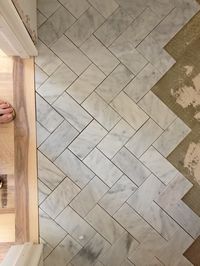 Subway tile in a herringbone pattern on the floor or backsplash.