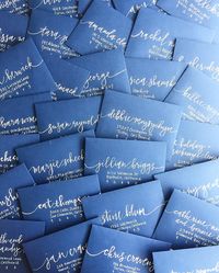 Navy and white invitation envelopes for a nautical baby shower. Calligraphy by Sea Calligraphy.