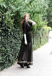Olivia Emily wears Killstar Mesh Top, Dark Thorn Chastity Sheer Maxi Skirt, Asos Harness and Unif Dedi Boots