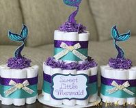 Gorgeous sea-themed baby shower cake with a baby mermaid to top it off.