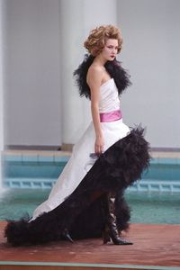 2000 Dramatic ball gowns, leather boots, and bold eyeliner made statement on Fall/Winter Haute Couture runway in 2000.
