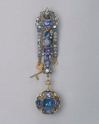 Watch on a chatelaine, by Charles Carbier, English, c. 1720. Chased and engraved; made of gold, silver, sapphires, enamel, glass, and metal alloys. From the Hermitage Museum.