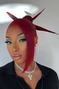 Megan Thee Stallion jumped on the spiky bun trend, too. The rapper styled her velvet red hair into a sleek side fringe and ballerina bun, with thick dramatic spikes protruding out of the sides. See what other celebs are rocking the 00s spiky bun look...