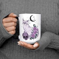 "Floral Cat Skeleton Moon Witch Mug It comes in 4 styles of witch options (shown in photos) Comes in multiple mug options 15oz with black handles and inside as shown 15oz with a pink handle and inside 15oz all white 11oz all white You can order it with just the design or add a name to it if you'd like. Printed on only the highest quality mugs that will never fade no matter how many times you run it thru the dishwasher or wash it White Ceramic mugs, with round C shaped handle Mugs are Designed, P