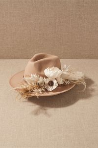 Add a Western-inspired detail to your look with this adjustable hat, topped with preserved flowers.Only available at BHLDN
