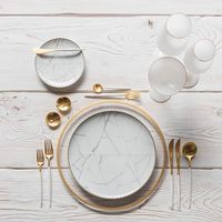 Our Halo Glass Chargers in 24k Gold + Carrara Dinnerware + Goa Flatware in Brushed 24k Gold/White + Bella 24k Gold Rimmed Stemware in White + 14k Gold Salt Cellars + Tiny Gold Spoons