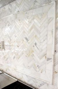 Arabescato Carrara Herringbone Pattern 1x2 Honed backsplash.