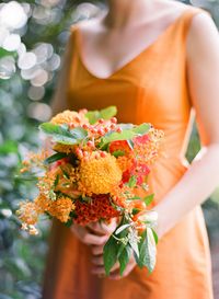 Orange bridesmaid dress + Orange bouquet | Eric Kelley