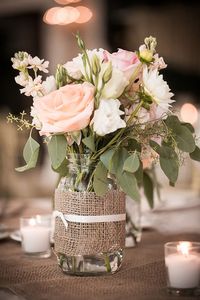 Mason jar flower arrangements in blush pink. More
