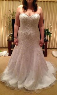 Our US dress design firm offers white plus size wedding dresses with silver beading for added bling. This strapless bridal gown design looks lovely on a curvy figured bride. The sweetheart bust line and a-line skirt add to the over all look. See other plus size wedding dresses for inspiration at http://www.dariuscordell.com/featured_item/plus-size-wedding-dresses-bridal-gowns/