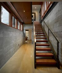 The wood treads on this open stairway add just enough warmth to balance the cool tones of the surrounding concrete walls. Designed by Rehkamp Larson Architects, Minneapolis, Minn. Photo by Ken Gutmaker.