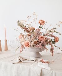 Planning a wedding on a budget? Afloral has you covered! Create your own stunning floral arrangements with repurposable faux and dried flowers and an elegant compote bowl. Shop this entire look and recreate this stunning tablescape for your fall wedding at Afloral.com.