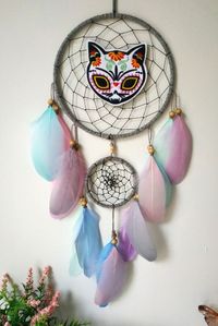 Spooky Cat dreamcatcher, pastel goth bedroom wall decor, gift for cat lovers A one-of-a-kind, cool interpretation of the traditional dream catcher. Hang this lovely dream catcher to catch bad dreams while you sleep or bring good vibes into your space. Materials: ~ two metal rings, gray yarn ~ black nylon string, silver beads ~ wooden beads ~ pastel color feathers ~ embroidered goth cat