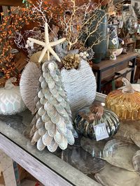 Please visit our main website- www.LovingCoastalLiving.com We will be minimizing our offerings on Etsy soon! The beautiful Silver toned Abalone Shell Tree is decorated from tip to top in all abalone revealing the natural iridescence of the inside of the shell. Every small area is covered, and it displays nicely from all angles. We've topped the tree with a beautiful white finger starfish. The shell tree is perfect for decorating in a beachy style this Holiday, but is truly a perfect piece to dis