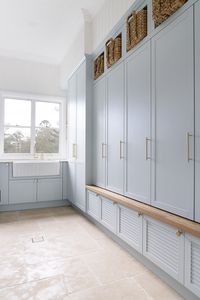 A new build in the charming Brookfield area of Brisbane, this home melds the best of country interior design with coastal and luxe influences. Gorgeous classic home that screams for a holiday asap! Laundry mudroom styling: blue laundry, storage, mudroom, mudroom storage, mudroom in laundry, farmhouse sink, butlers sink, luxe laundry, gorgeous laundry, beautiful laundry, basket storage, window in the laundry. Check out more of this beautiful home by clicking the pin!