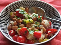 The classic side dish of rice and beans gets a summery facelift in this bold, chilled salad, packed with tomatoes, sharp cheddar, onions, cilantro, and an in-your-face vinaigrette made with both banana peppers and ancho chilies.