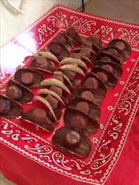 We made these cute and delicious cowboy hats by icing one side of a Pringles (regular flavor) chip with melted chocolate and then topping with an unwrapped Reese's peanut butter cup. If a bit of chocolate pulled off the bottom of the Reese's when we unwrapped it, we added a little melted chocolate to it, too. These were a big hit. Enjoy:)