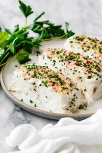 Baked halibut topped with a creamy, herbed mayonnaise crust is a dinner sensation! This quick and easy recipe gives you moist and flakey filets with an utterly delicious topping.