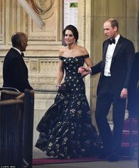 Leaving early: William helped his wife out of the venue as they made an early departure