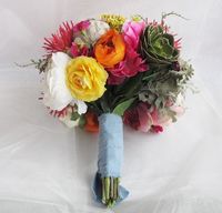 Create this beautiful bouquet by adding large stems first and taping with floral tape in groups of 3 stems. Keep adding to bouquet making sure to balance stems on every side. Finish with a blue muslin ribbon.