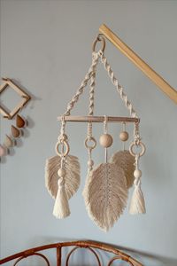 This Macrame Baby mobile with woodbase which can become a lovely decoration for any baby room or a crib. Beautiful baby mobile hanging is a great gift idea for newborns and will catch boho nursery decor perfectly.