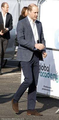 Prince William looked dapper in navy trousers and a grey blazer, which he teamed with brow...