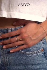 Dainty and minimal, but never understated. This handchain bracelet is made with an Italian Singapore chain that shimmers with every move. Comfortable to wear for long periods, you'll never want to take this off! Handmade in NYC