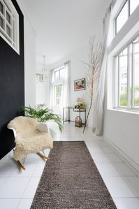 You don’t always have to do an elaborate routine to make your entryway stand out. All it takes to distinguish the space is clever demarcation. In Anjali Mangalgiri’s home, a soft rug and rocking chair are the only furniture elements in her entryway. What makes them eye-catching is the black wall that stands in stark contrast to the rest of the house. Image courtesy, Grounded