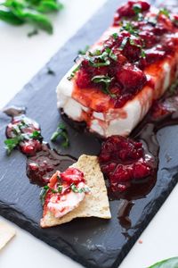 The easiest and most flavorful cream cheese dip I've ever tasted! Perfect for a crowd and always gets gobbled up fast! The combined flavors of fresh basil, balsamic vinegar, and strawberry sauce over the cream cheese is divine! #dip #creamcheesedip | recipesworthrepeating.com