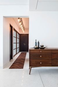 Form and function are the cornerstones of mid-century design. This dark wood console with straight lines and non-embellished design, coupled with the simplistic knobs is a prime example of mid-century modern design. Image courtesy, Ira Gosalia phxindia for We Design Studio