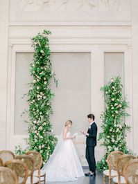 Leaf + Petal created a dramatic ceremony setup for a New Orleans garden wedding at the New Orleans Museum of Art. With blush, peach, and neutral garden roses, ranunculus, and delphinium and lush overgrown greenery, the setup beautifully framed the couple as they exchanged vows.