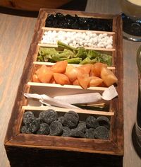 "A wooden box filled with tar pastilles, meadow sweet candy, anise seeds coated in crystallised honey and bees wax, dried arctic angelica, dried black currants"