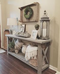 Living Room decor - rustic farmhouse style grey wood x brace console table with baskets, lantern styling | Homedecormomma